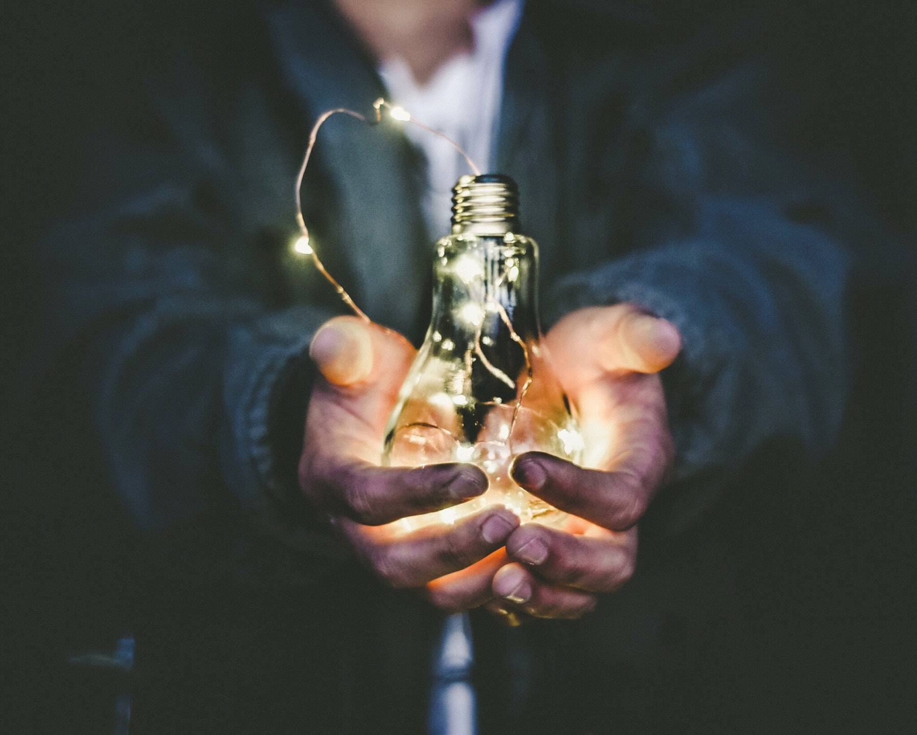 man holding bulb energy saving