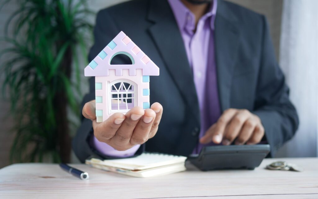 man housing advisor holding house model edited